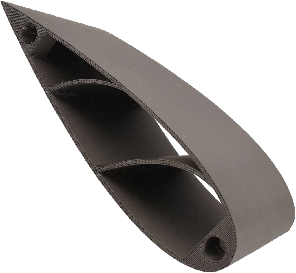 An aerodynamic duct part 3D-printed in 3DXTech CarbonX PC+CF, showing the matte carbon-fiber surface and clean layers
