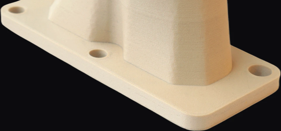 Mounting flange of a PEI+GF30 printed part with bolt holes, showing rigid structural walls