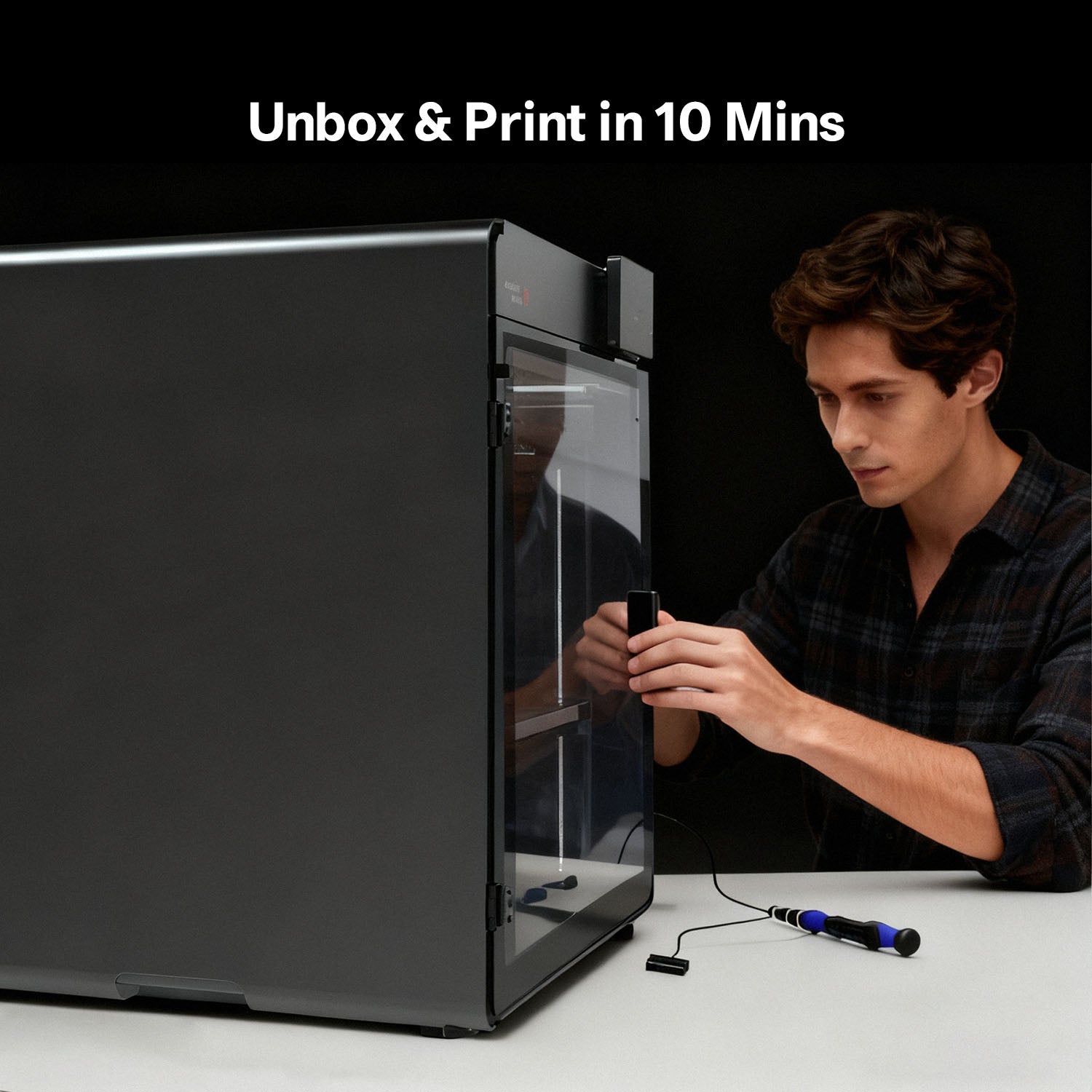 Operator closing the door of an Anycubic Kobra S1 Max Combo during a quick setup, side view