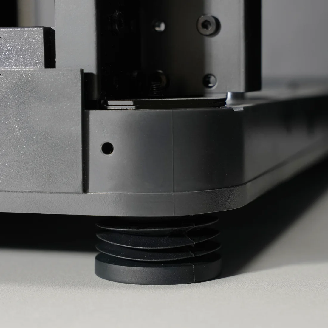 Bambu Anti-Vibration Foot installed on a printer corner, isolating it from the surface
