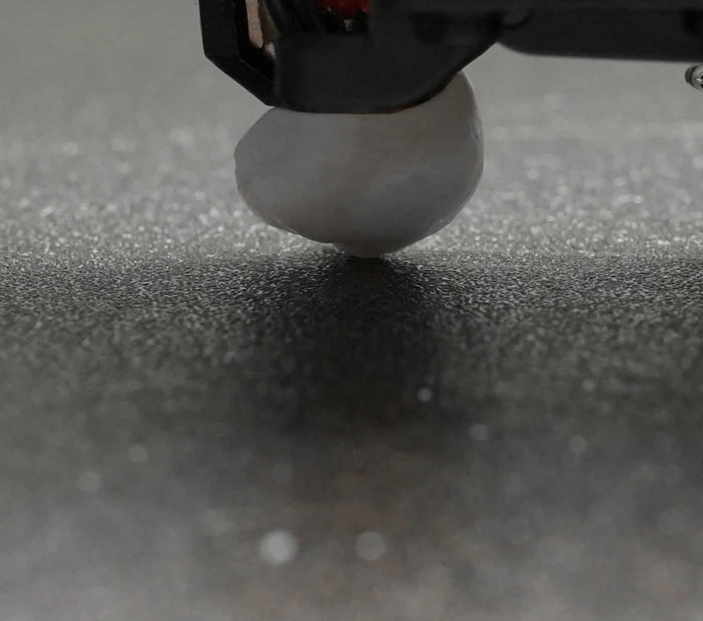 Bambu Lab H2D servo-driven toolhead extruding molten filament in a close-up