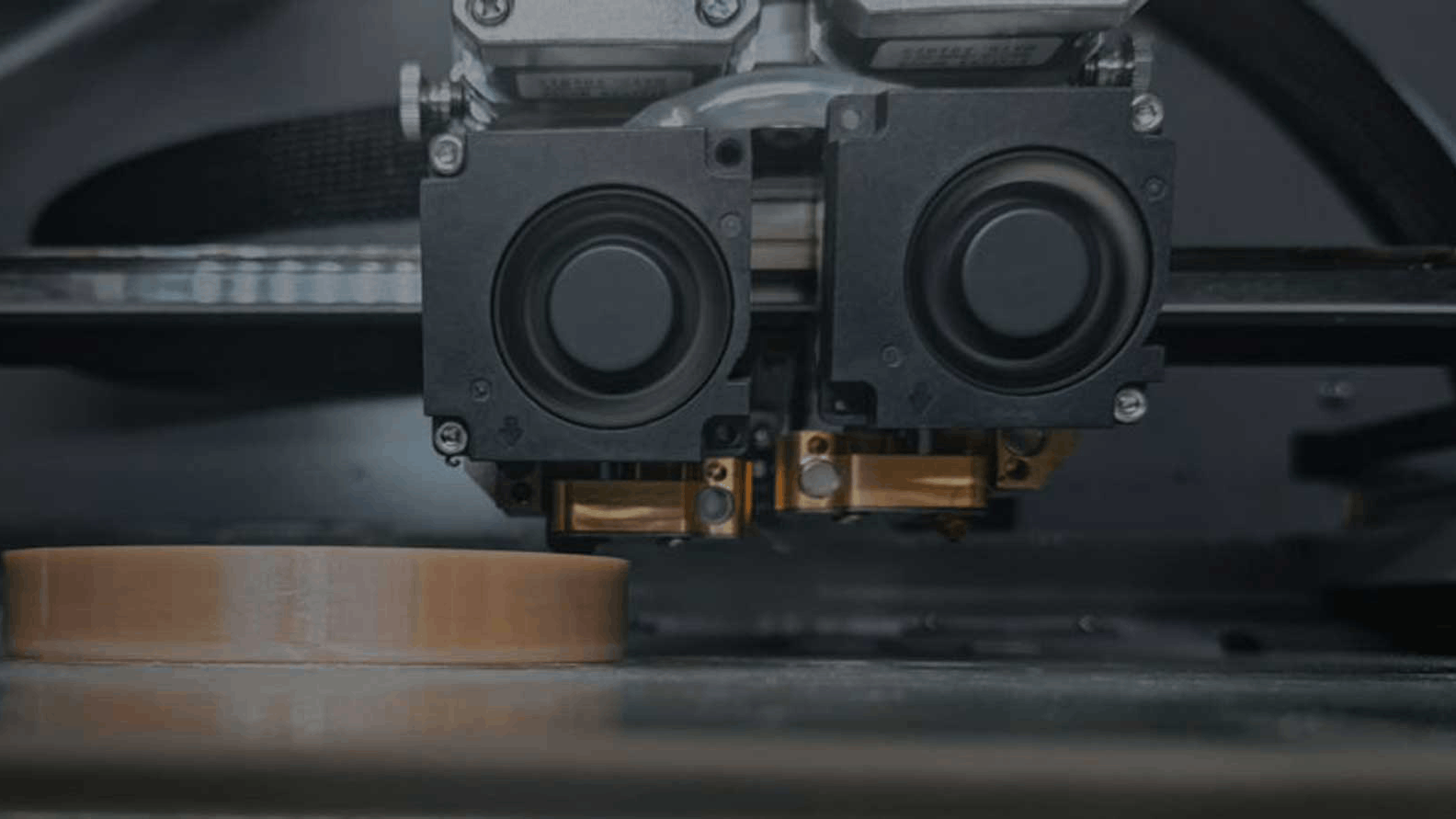 CreatBot PEEK-300 water-cooled dual print head with twin cooling fans laying down a high-temperature PEEK part