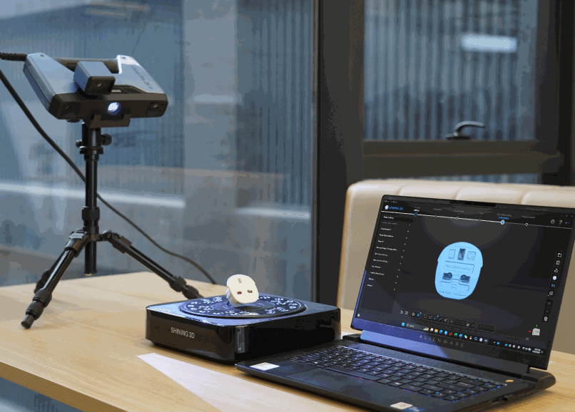 EinScan Pro 2X V2 Fixed-Scan on a tripod scanning a small object on an automatic turntable, laptop beside