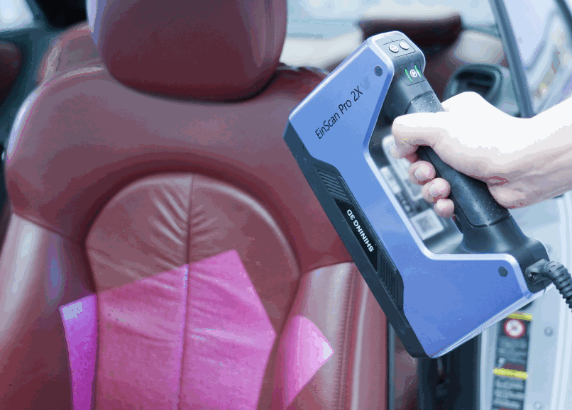 EinScan Pro 2X V2 handheld scanning the leather interior of a car &mdash; automotive aftermarket 3D scanning