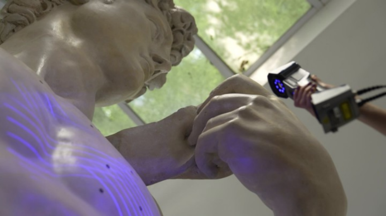 EinScan Pro 2X V2 handheld scanning the detailed surface of a marble sculpture with blue structured light