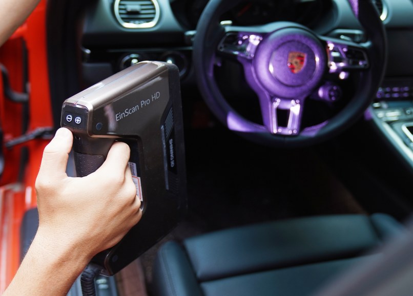 EinScan Pro HD handheld scanning a car interior and steering wheel in tight access