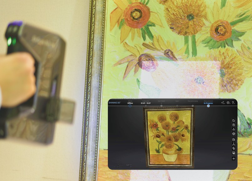 Operator hand-scanning a framed Van Gogh Sunflowers relief with the EinScan Pro HD, live EXScan result on the tablet