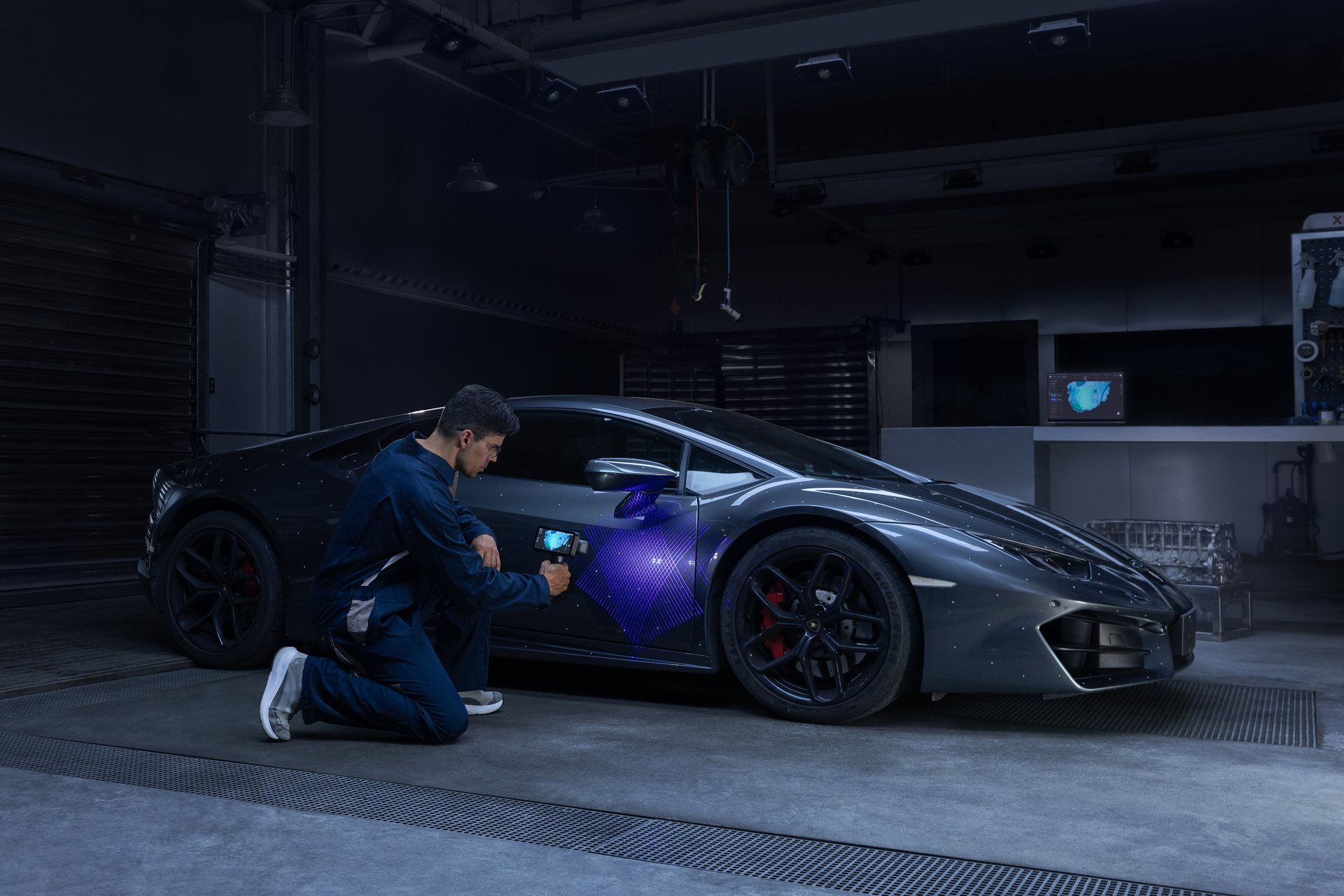 Technician scanning a sports car body panel with the EinScan Rigil in a garage &mdash; automotive aftermarket 3D scanning