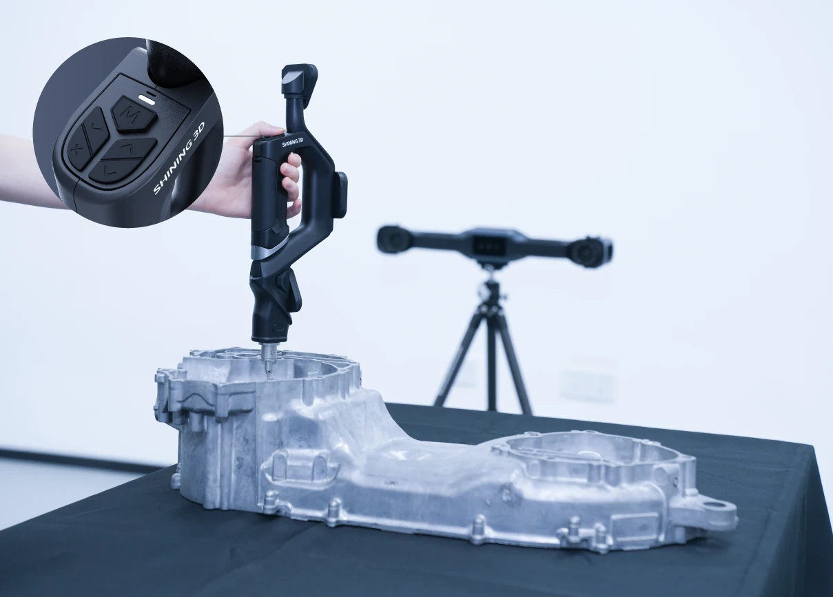 SHINING 3D FreeProbe hand-probing a metal casting while a FreeScan Trak tracker on a tripod references it