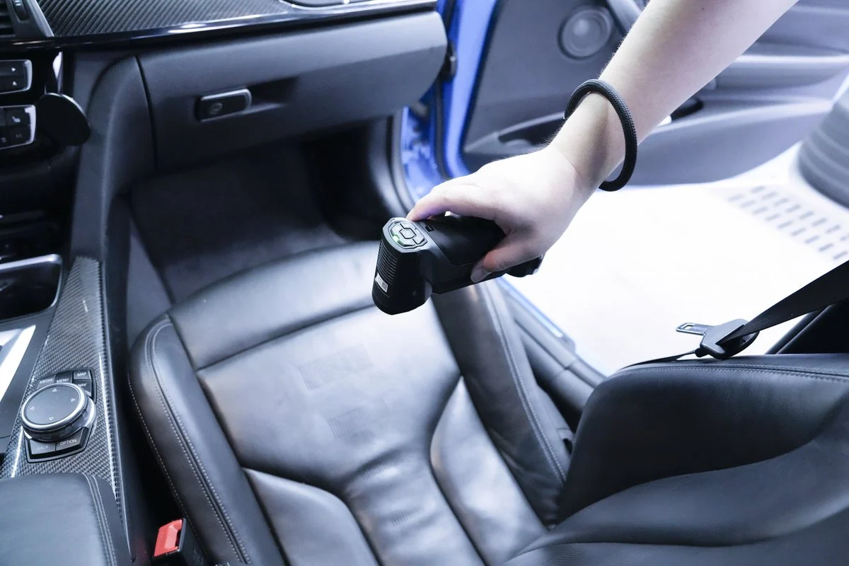 Hand scanning a leather car seat with a FreeScan Combo+ Wireless