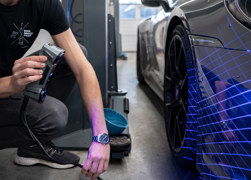 FreeScan Combo Series scanning a sports-car body with blue laser and a live mesh overlay