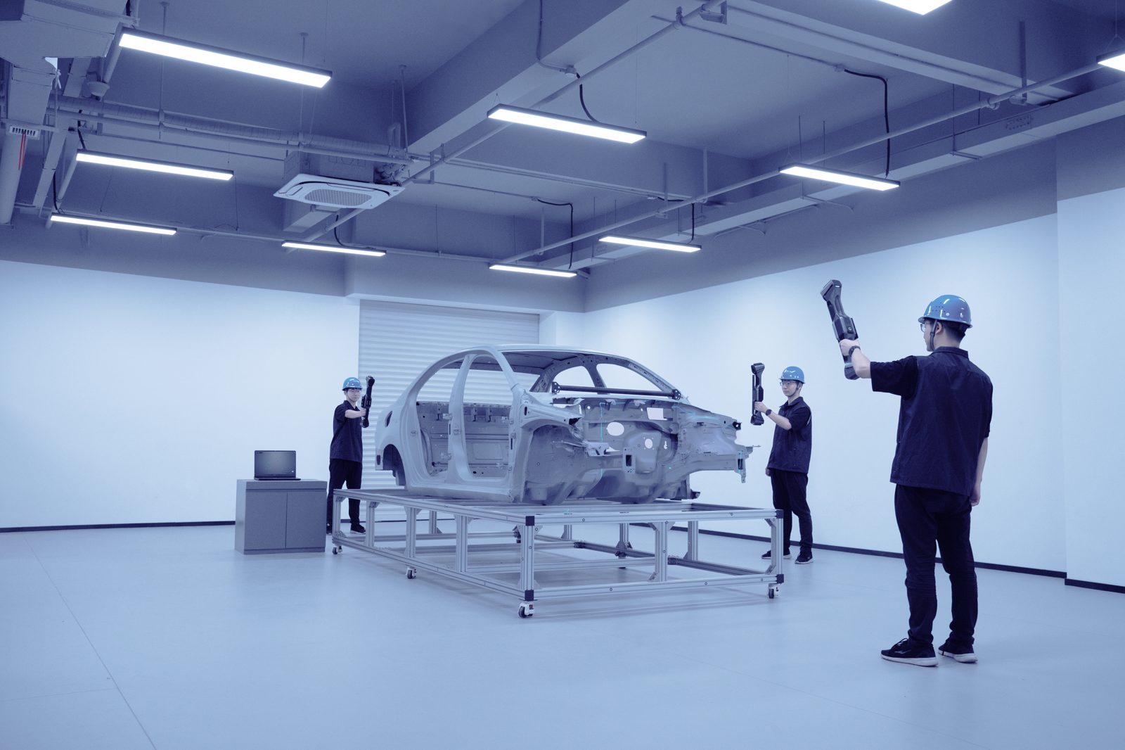 Inspection team digitizing an automotive body-in-white frame with FreeScan UE Nova handhelds for part-to-CAD analysis