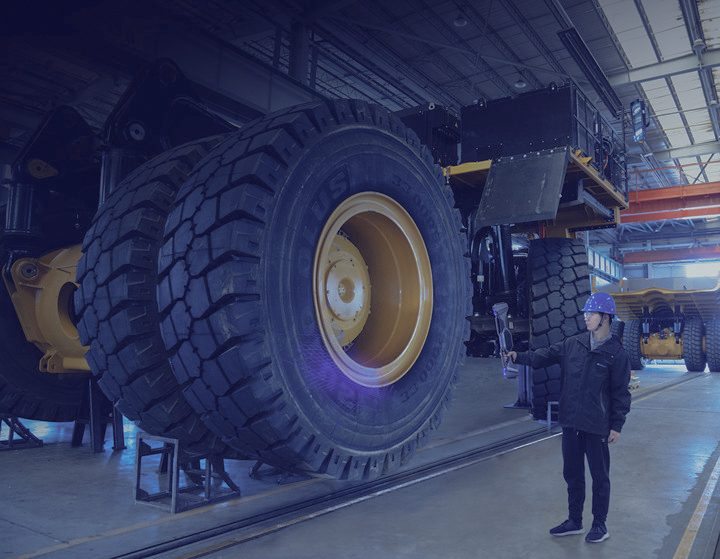 FreeScan UE Nova wirelessly scanning a giant mining haul truck and tyre inside a maintenance workshop
