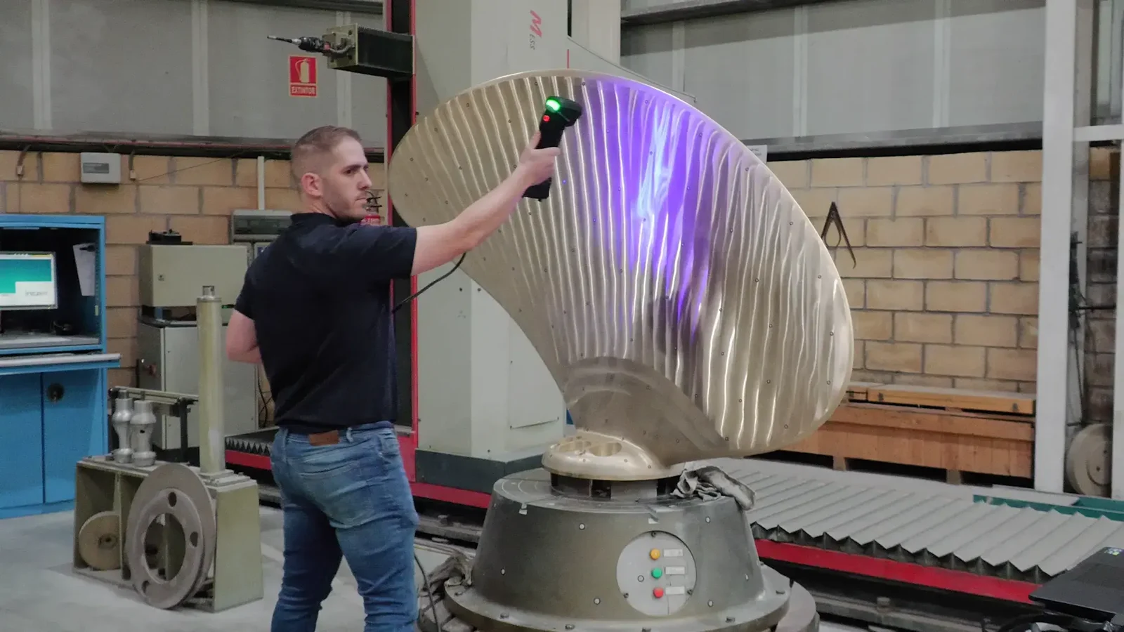 Operator using the FreeScan UE Pro to scan a large bronze ship propeller blade for inspection and reverse engineering