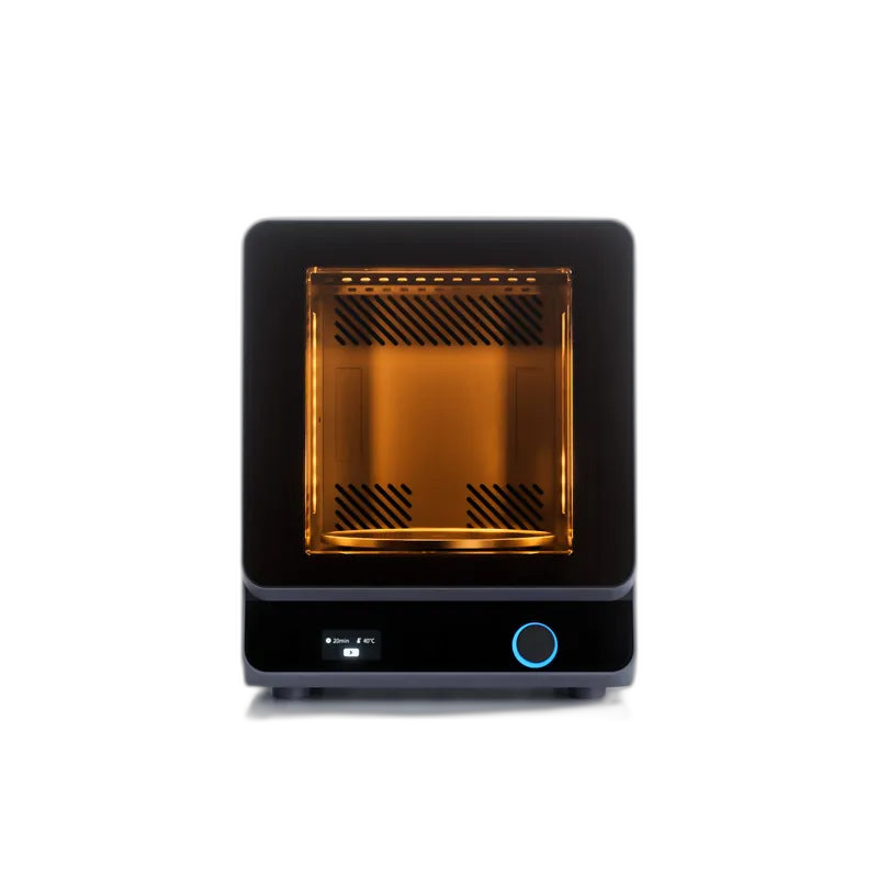 HeyGears UltraCraft Cure chamber glowing amber during a heated UV curing cycle, screen showing time and temperature