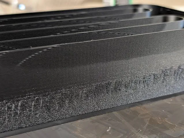 Close-up of the printed max flow rate part showing where the surface degrades