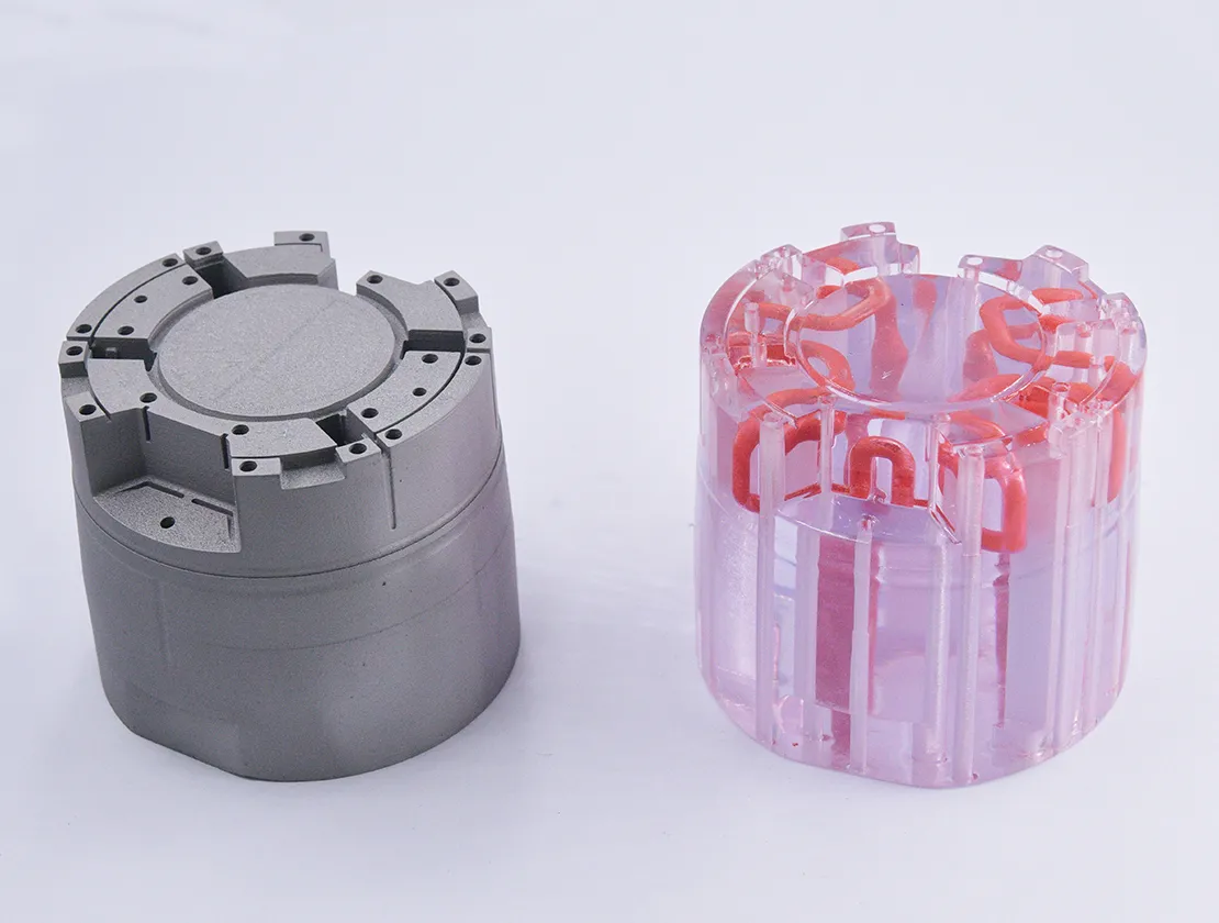 Grey opaque part beside a transparent resin part revealing internal red channels &mdash; Kings industrial SLA complex functional parts
