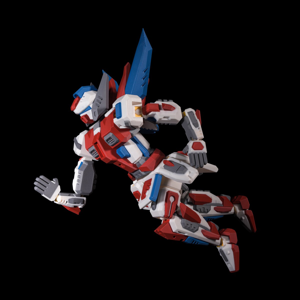 Multi-material printed robot mech in an articulated pose, printed in red, white, blue and grey on the Bambu Lab H2C