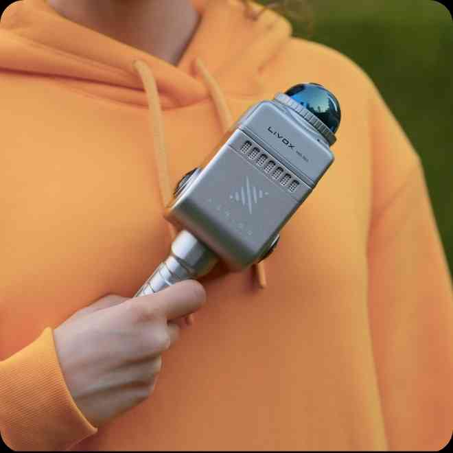 LixelKity K1 compact handheld 3D scanner being carried at hip height in indoor space, demonstrating walk-and-scan operation