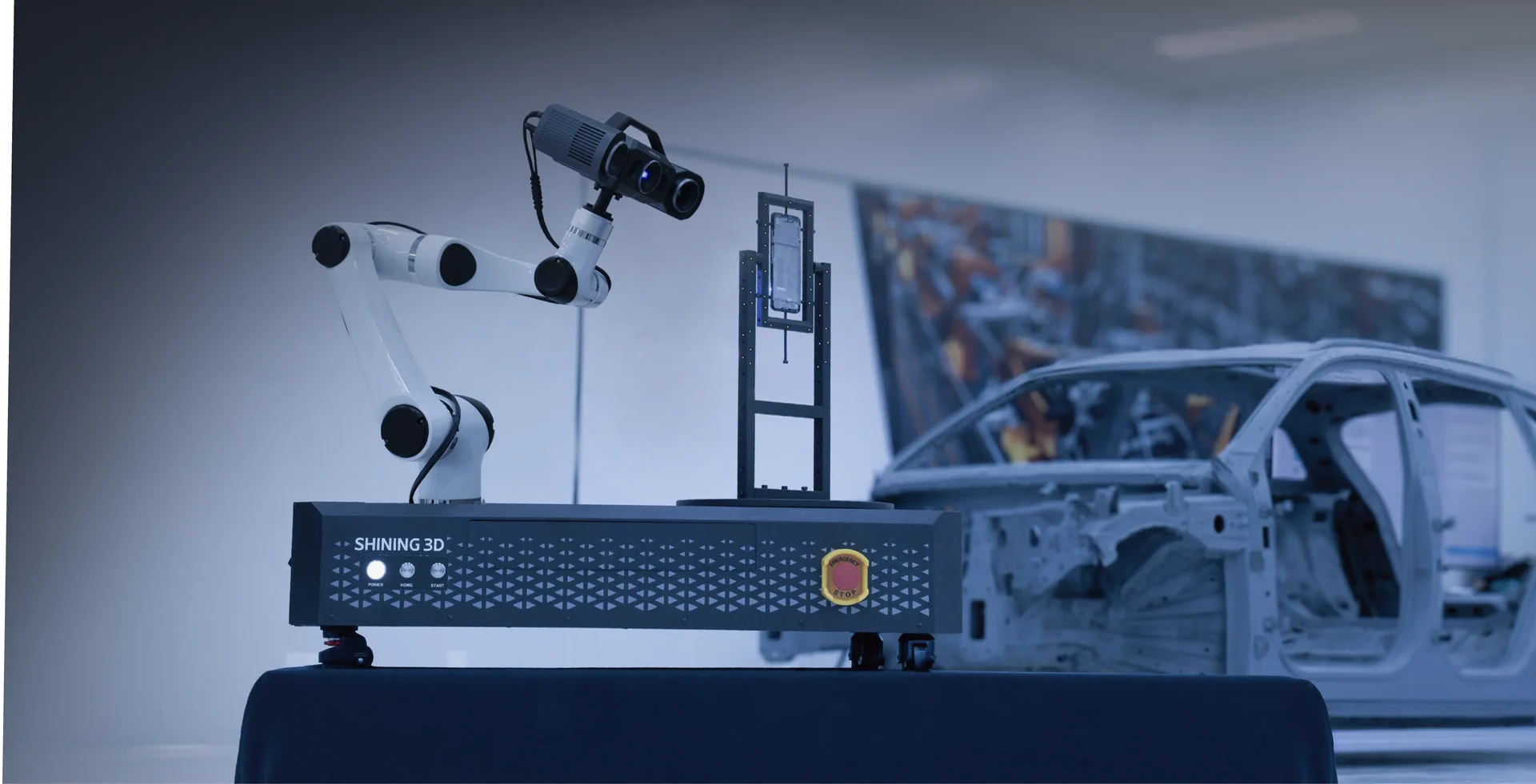 OptimScan Q12 robotic inspection cell scanning parts beside an automotive body-in-white production line