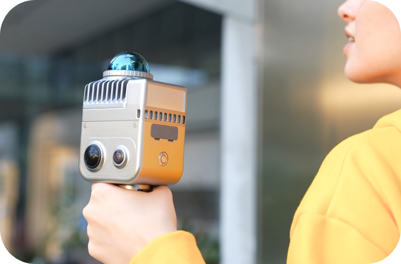 XGRIDS LixelKity K1 held one-handed outdoors &mdash; 360-degree LiDAR dome and dual panoramic cameras facing the scene