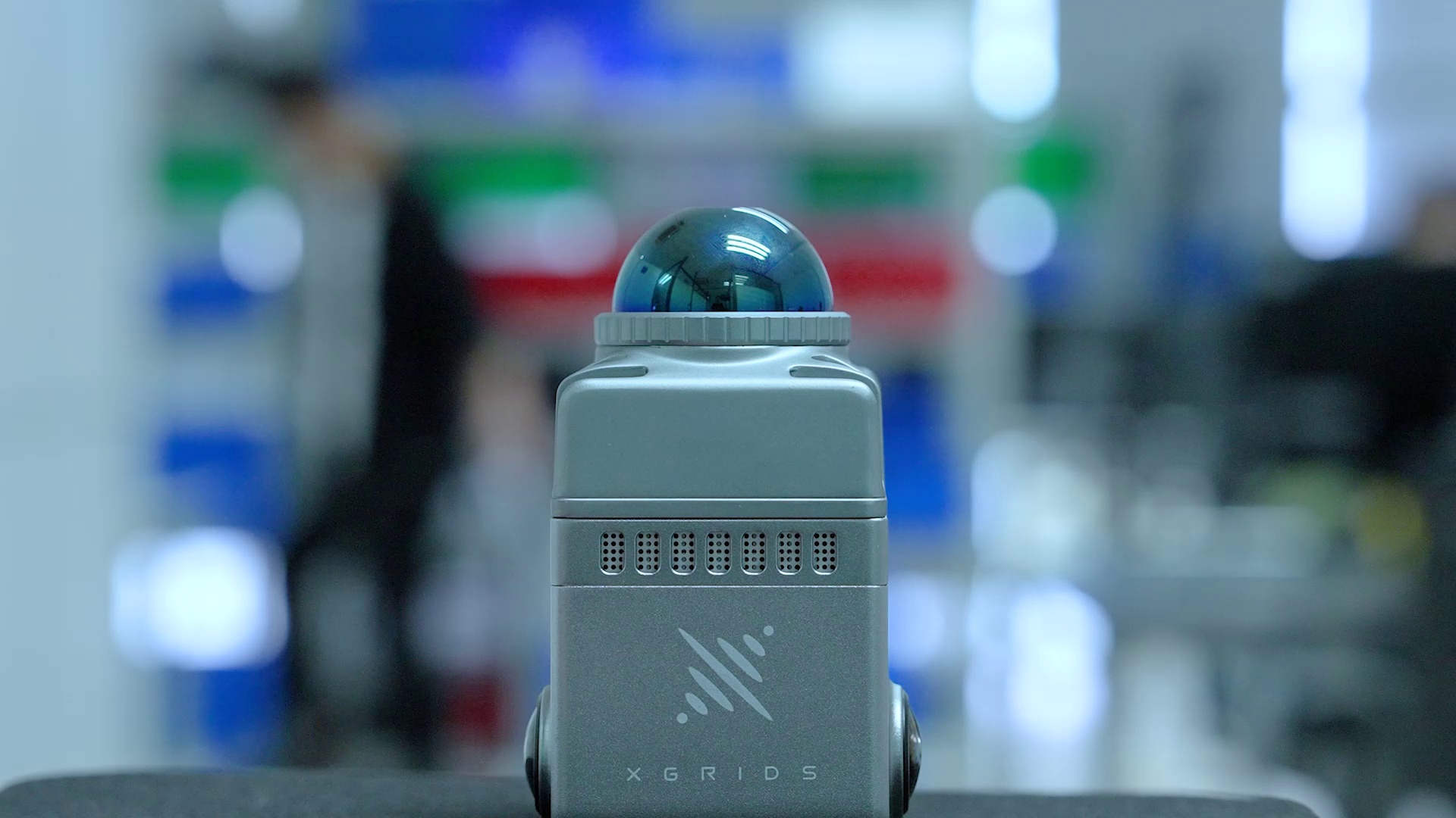 XGRIDS LixelKity K1 demonstration video still &mdash; scanner close-up with 360-degree LiDAR dome in a lab