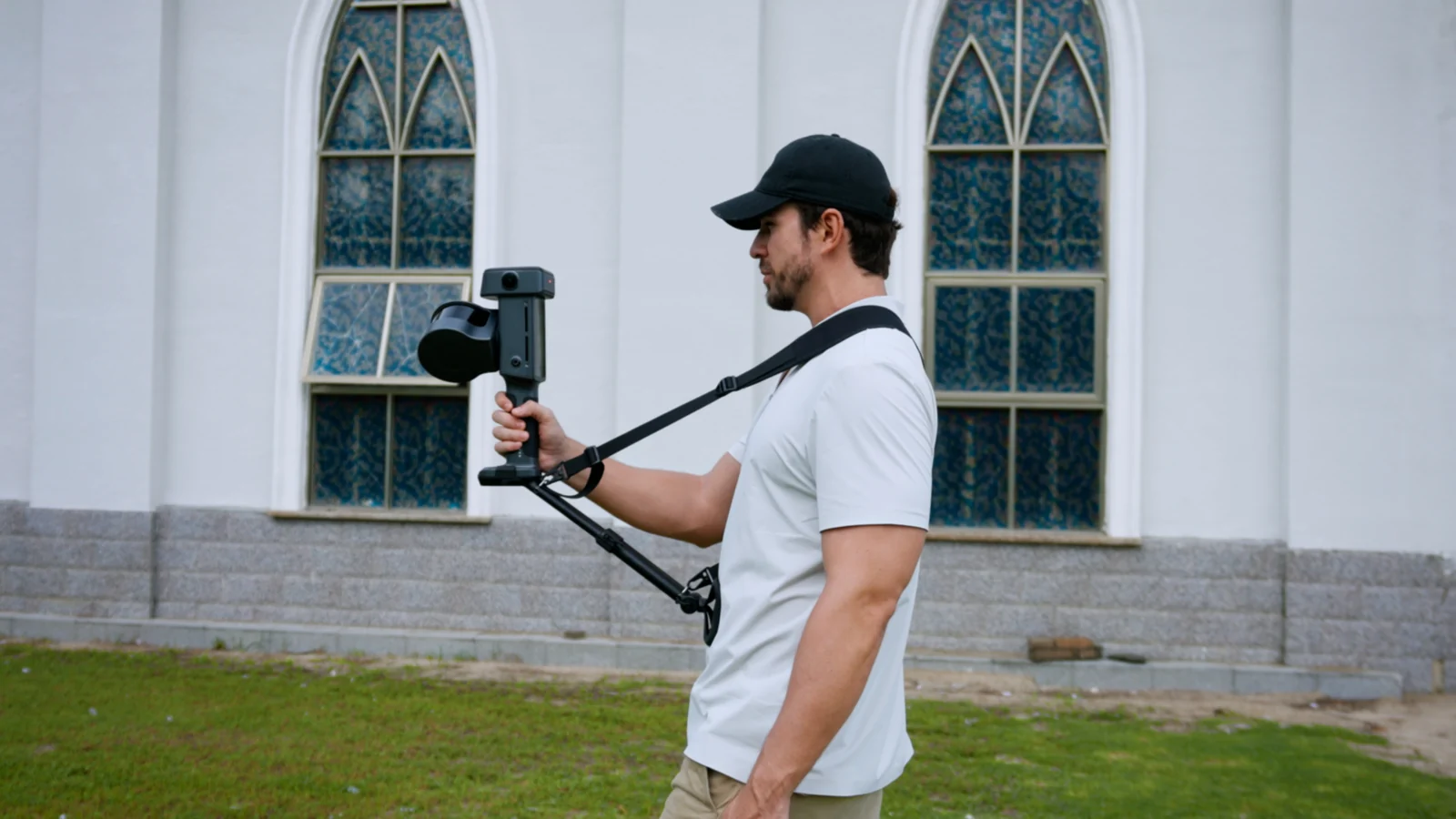 Operator carrying the Lixel L3 on a support rig and shoulder strap while scanning