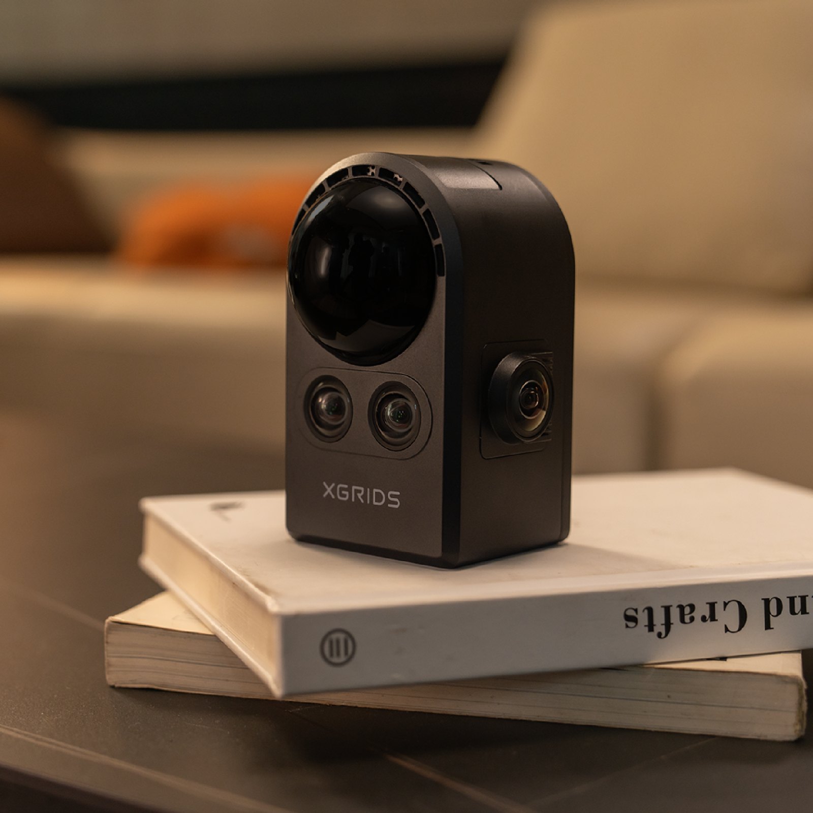 Close-up of the XGRIDS PortalCam showing the LiDAR dome, two front stereo cameras and side fisheye lens